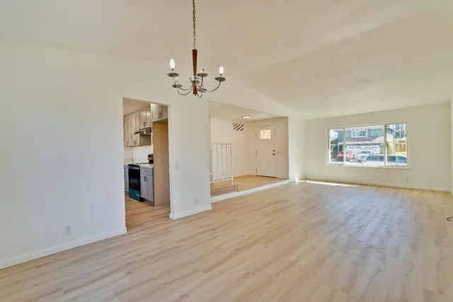 a kitchen with granite countertop a sink a stove and refrigerator