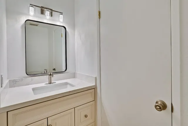 a view of a house with wooden fence