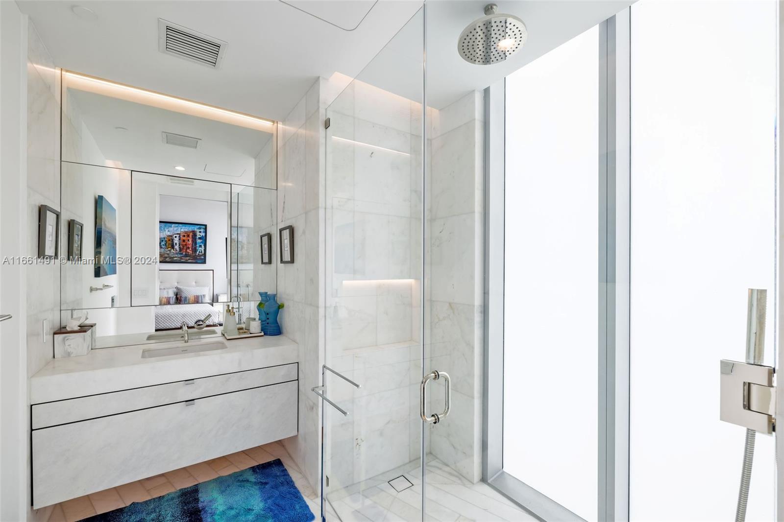 1300 Monad Terrace, Unit 9B Miami Beach, FL 33139 - Photo 12 of 34 a bathroom with a granite countertop sink mirror and shower