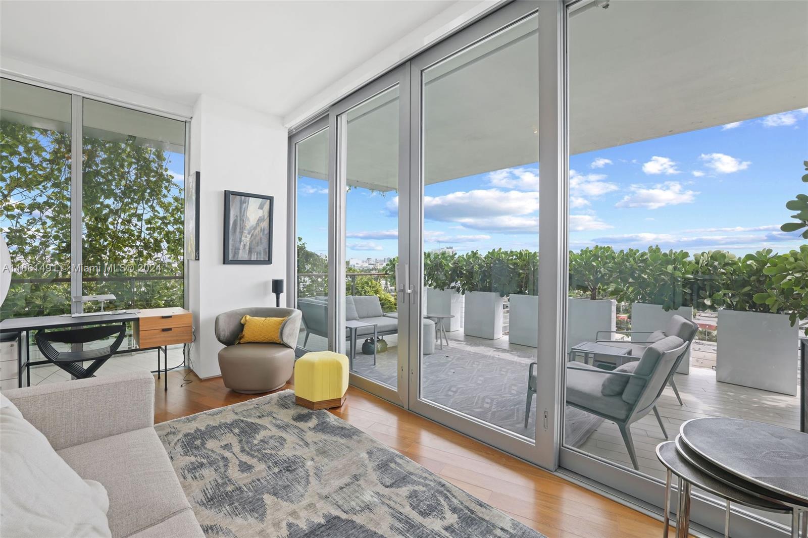 1300 Monad Terrace, Unit 9B Miami Beach, FL 33139 - Photo 13 of 34 a living room with patio furniture and a floor to ceiling window