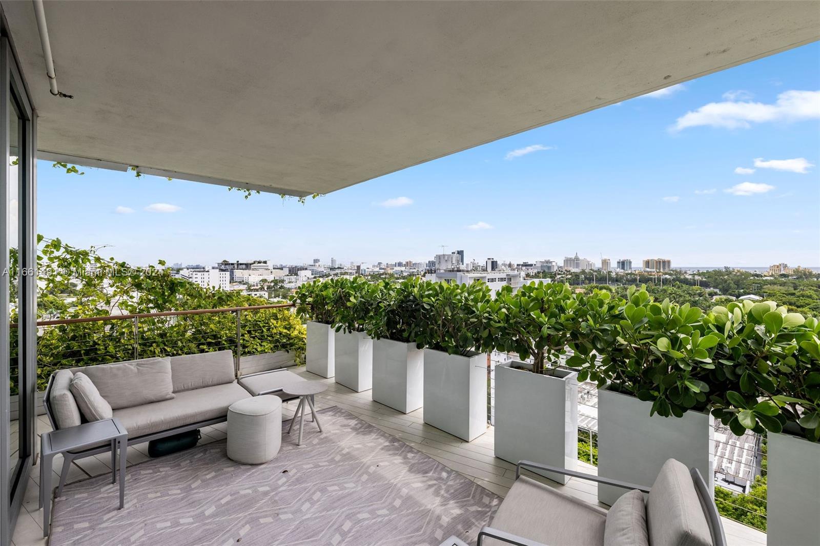 1300 Monad Terrace, Unit 9B Miami Beach, FL 33139 - Photo 16 of 34 a roof deck with table and chairs and potted plants