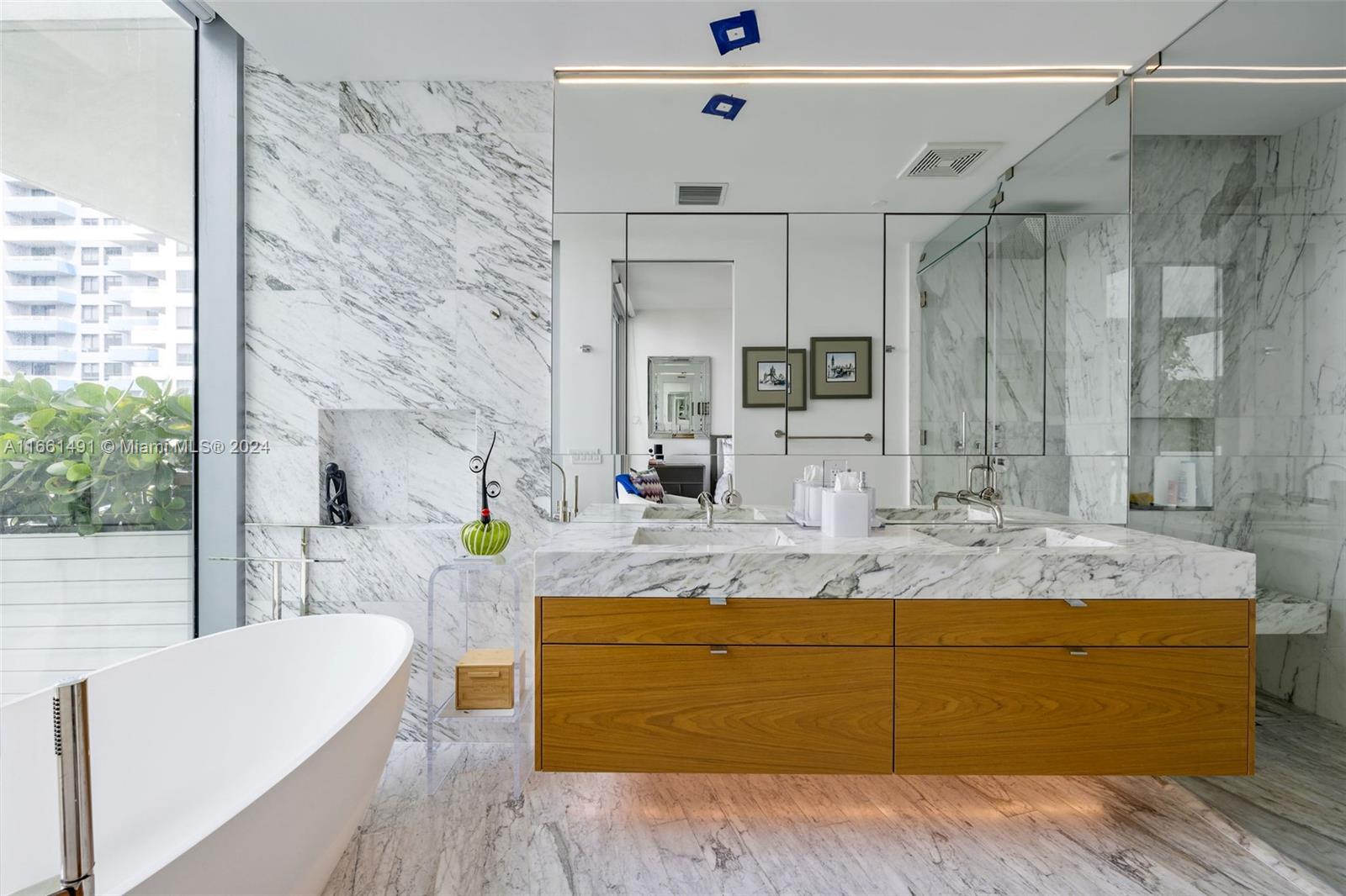 1300 Monad Terrace, Unit 9B Miami Beach, FL 33139 - Photo 23 of 34 a bathroom with a granite countertop sink mirror vanity and bathtub
