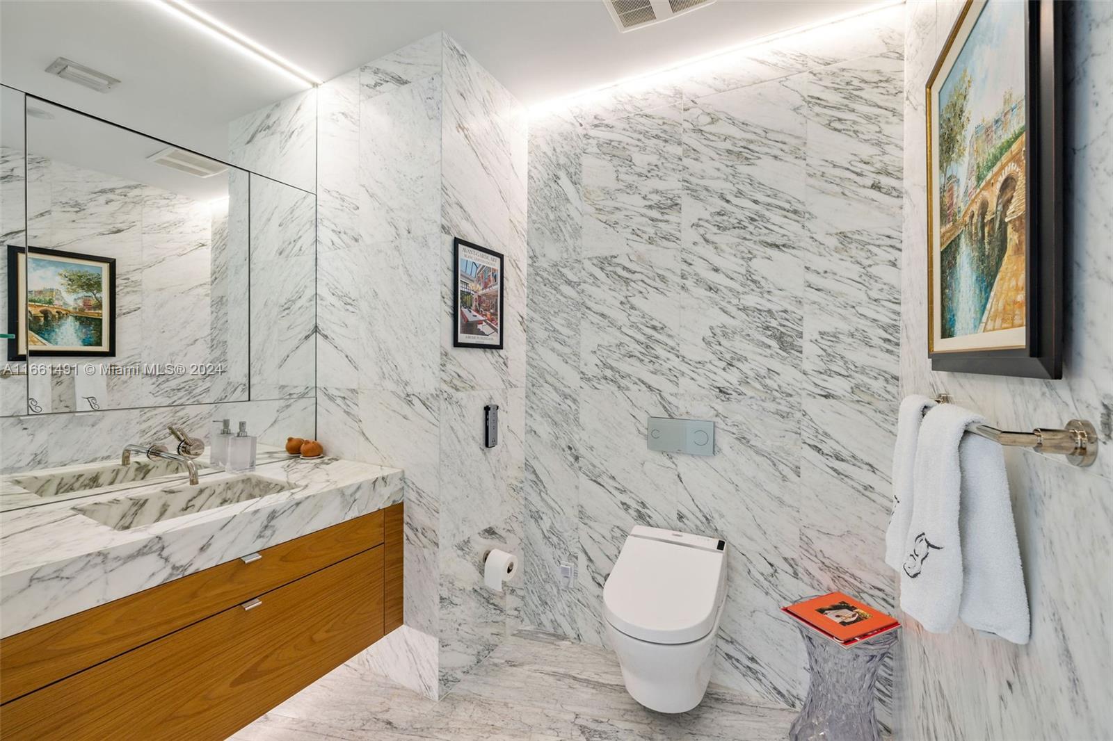 1300 Monad Terrace, Unit 9B Miami Beach, FL 33139 - Photo 24 of 34 a bathroom with a granite countertop toilet sink and mirror