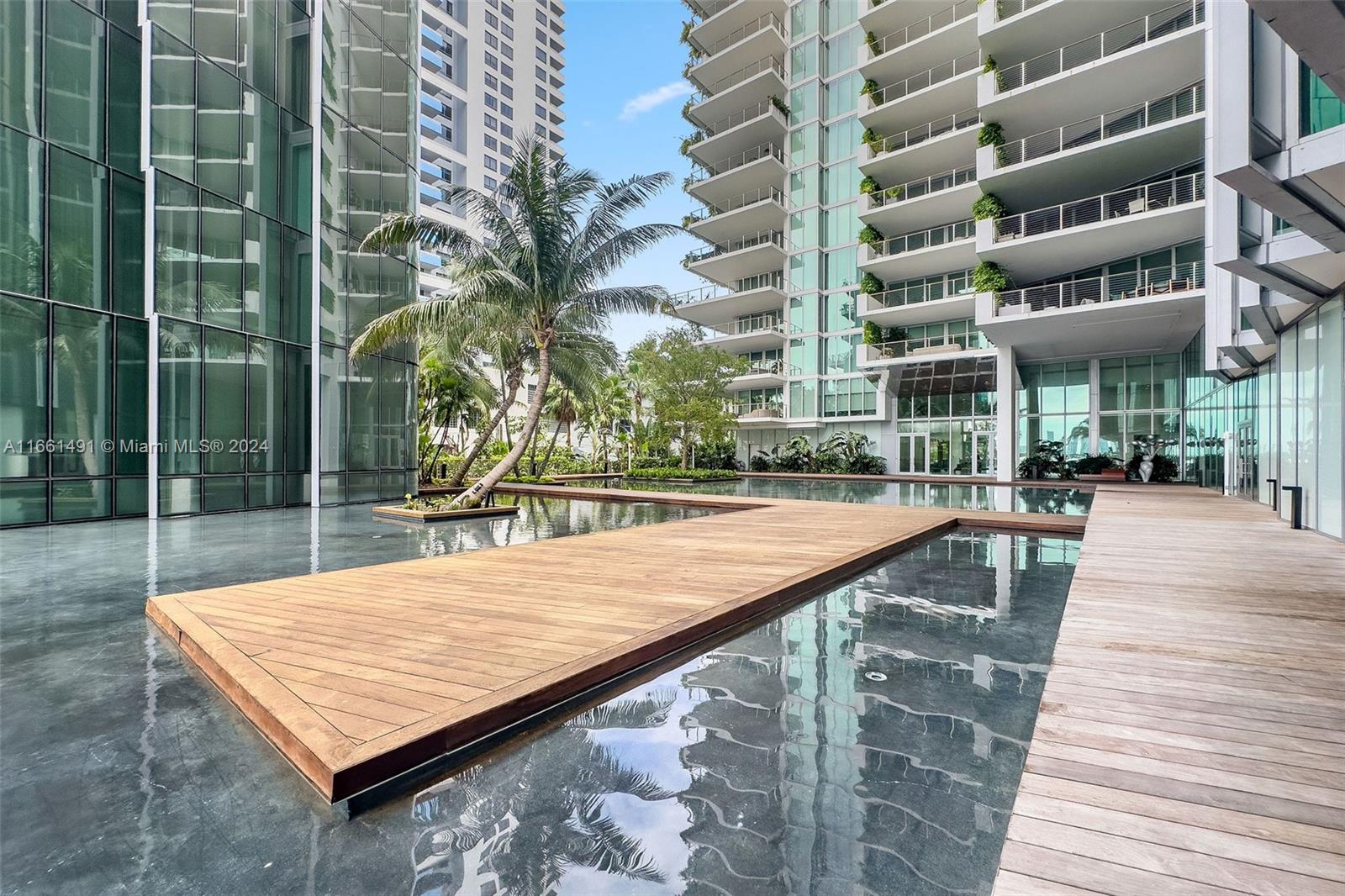1300 Monad Terrace, Unit 9B Miami Beach, FL 33139 - Photo 32 of 34 a view of a swimming pool with a lounge chairs