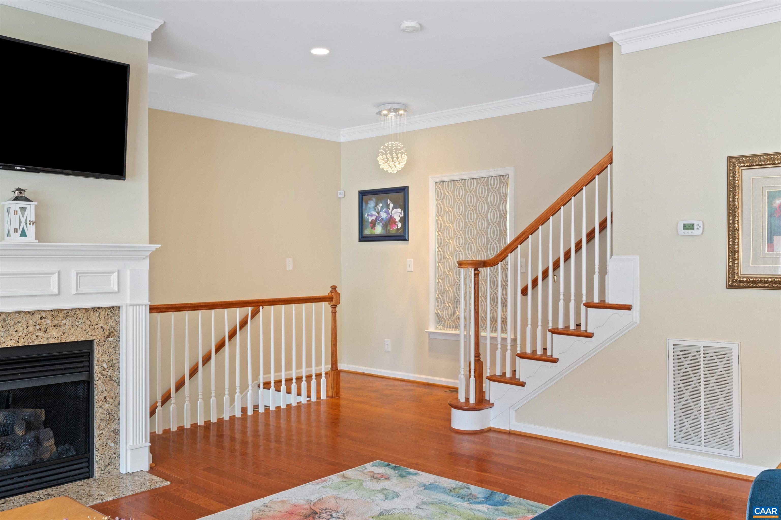 371 Quarry Road Charlottesville, VA 22902 - Photo 15 of 52 a view of a livingroom with furniture fireplace wooden floor and staircase