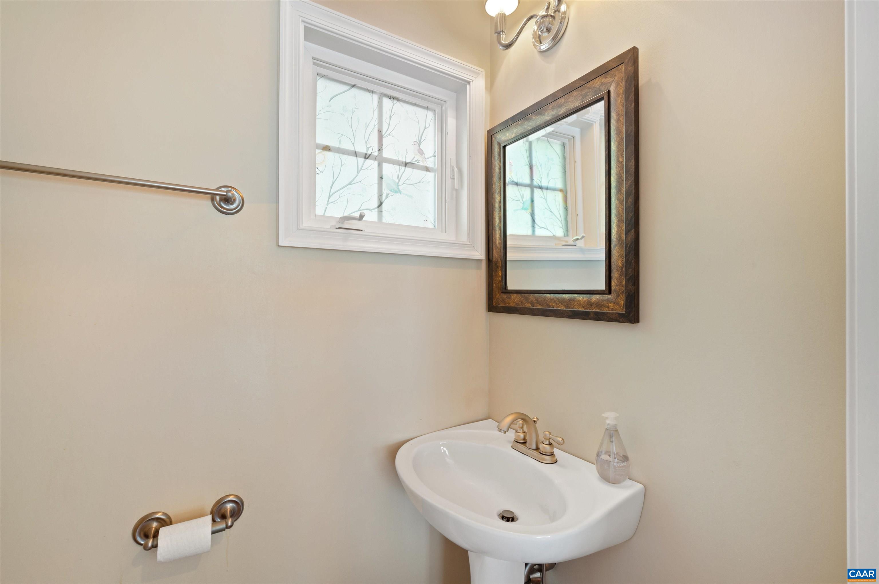 371 Quarry Road Charlottesville, VA 22902 - Photo 30 of 52 a bathroom with a sink a mirror and a window
