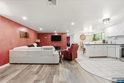 a living room with furniture a chandelier and a dining table
