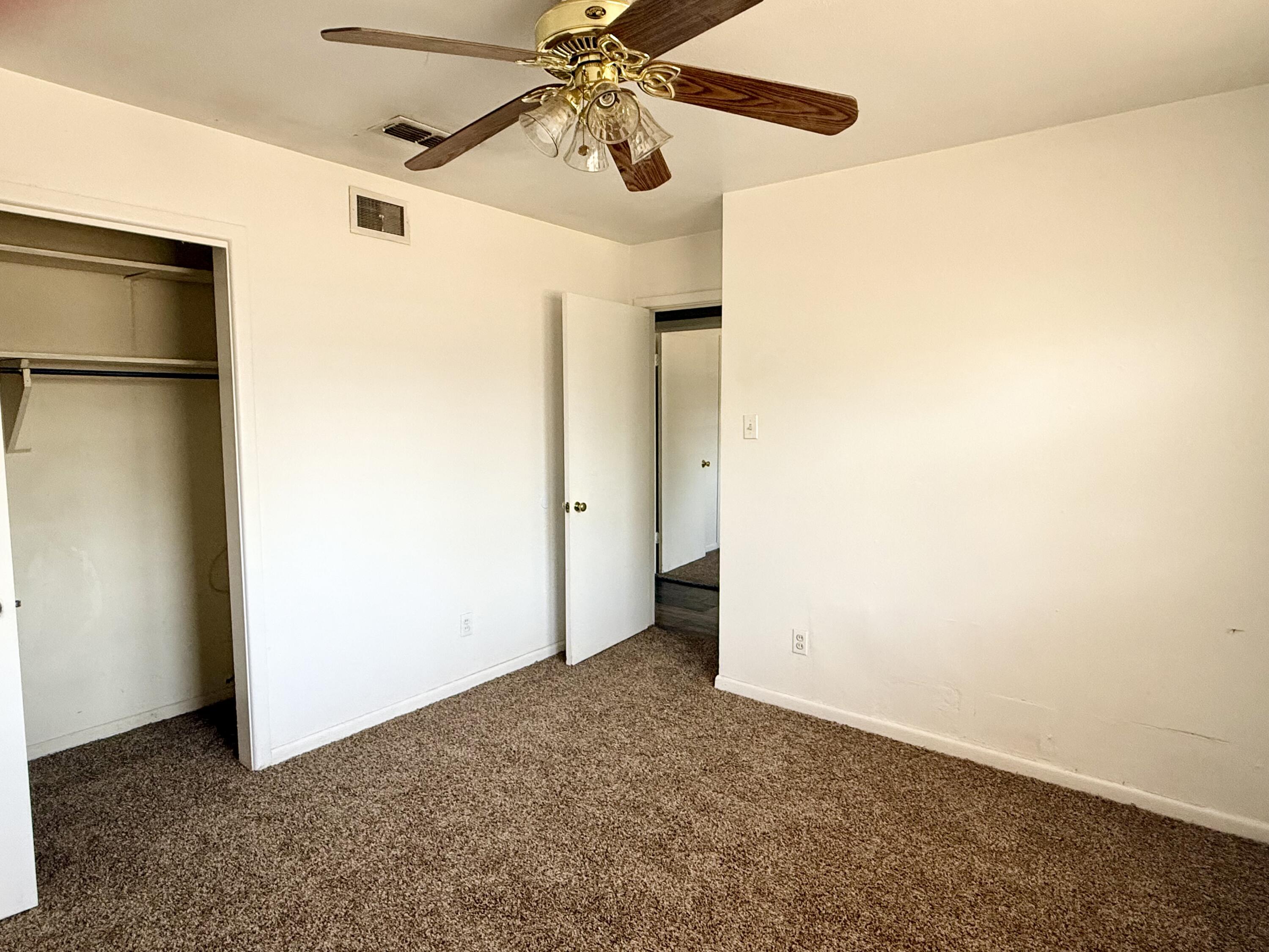 2817 63rd Street Lubbock, TX 79413 - Photo 6 of 16 an empty room with a ceiling fan and a window