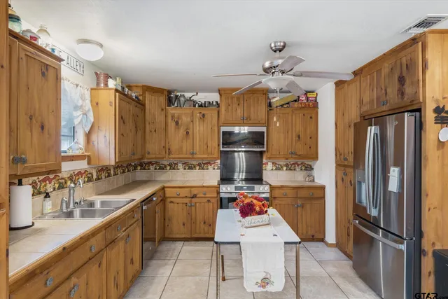 a kitchen with refrigerator cabinets and furniture