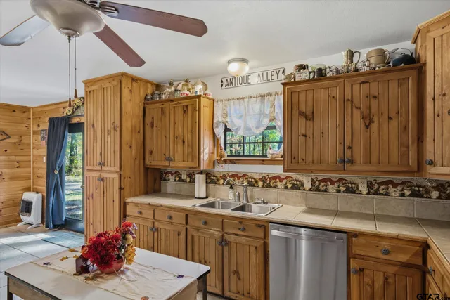 a kitchen with sink refrigerator and cabinets