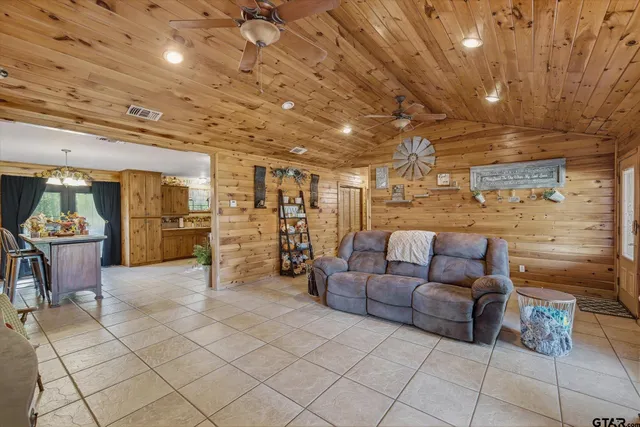 a living room with furniture and kitchen view
