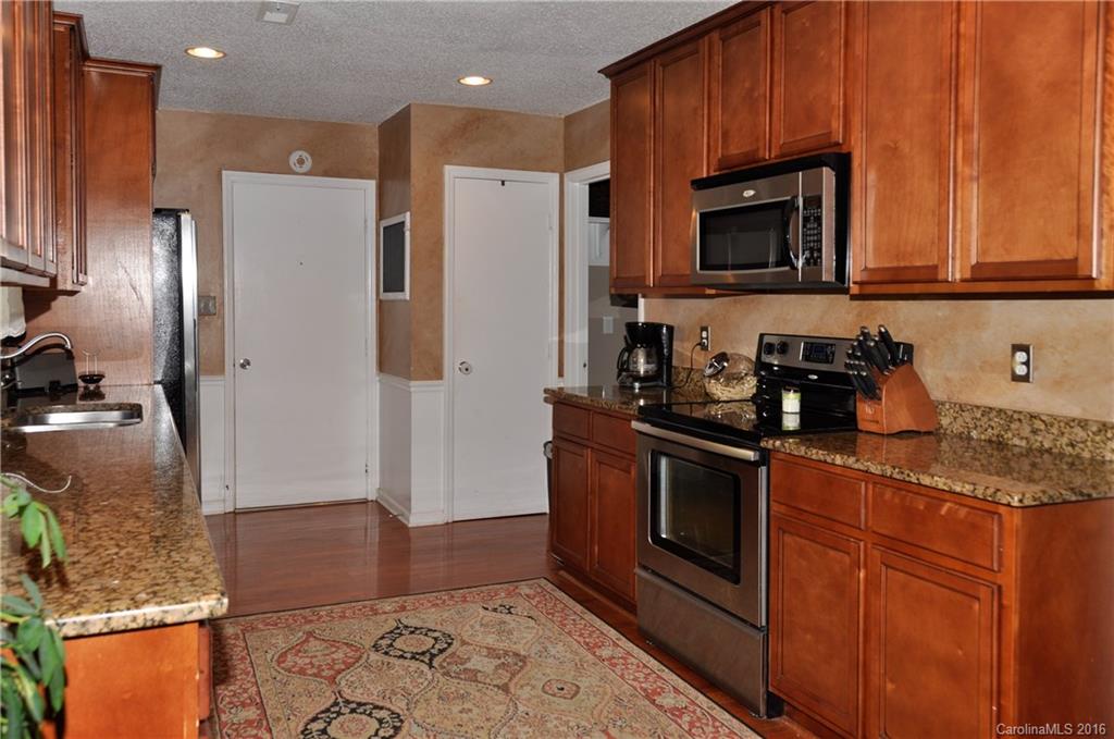 9924 Fairway Ridge Road Charlotte, NC 28277 - Photo 5 of 21 a kitchen with stainless steel appliances granite countertop a refrigerator stove and microwave