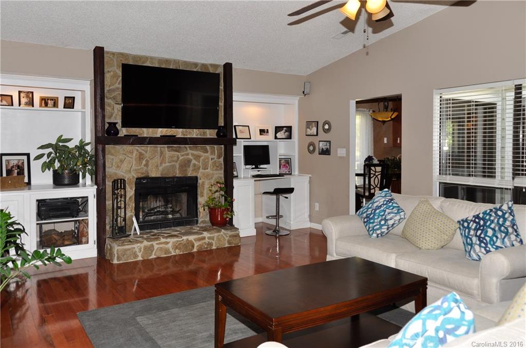 9924 Fairway Ridge Road Charlotte, NC 28277 - Photo 7 of 21 a living room with furniture a flat screen tv and a fireplace