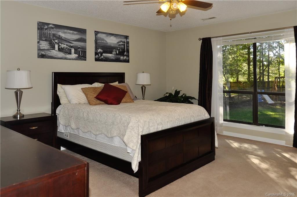 9924 Fairway Ridge Road Charlotte, NC 28277 - Photo 10 of 21 a bedroom with a bed and a lamp on dresser