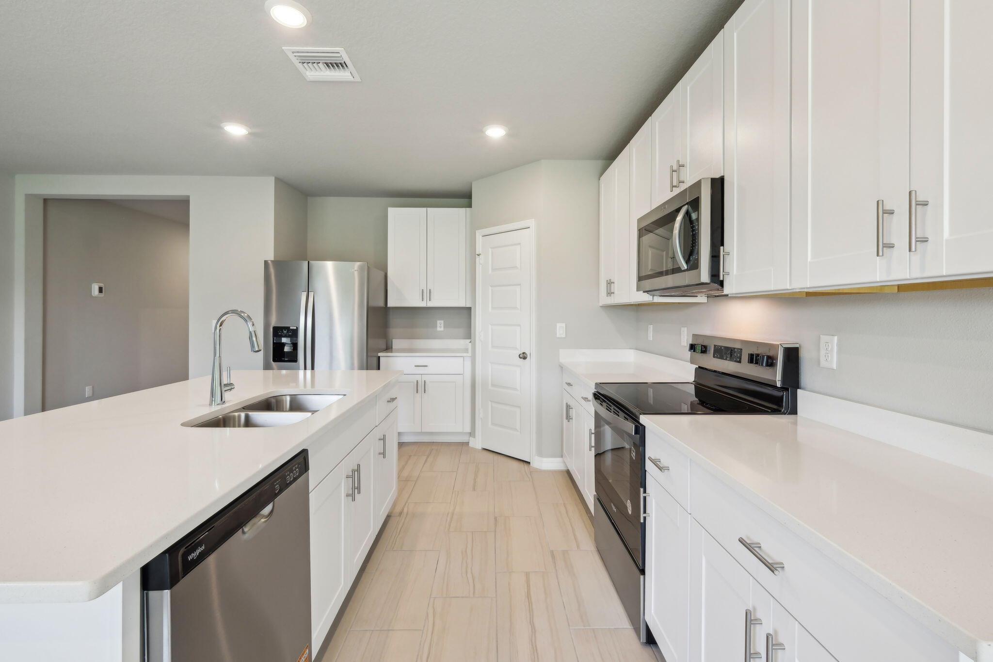 5413 Hampton Park Circle Vero Beach, FL 32966 - Photo 13 of 39 a kitchen with stainless steel appliances granite countertop a sink stove and refrigerator