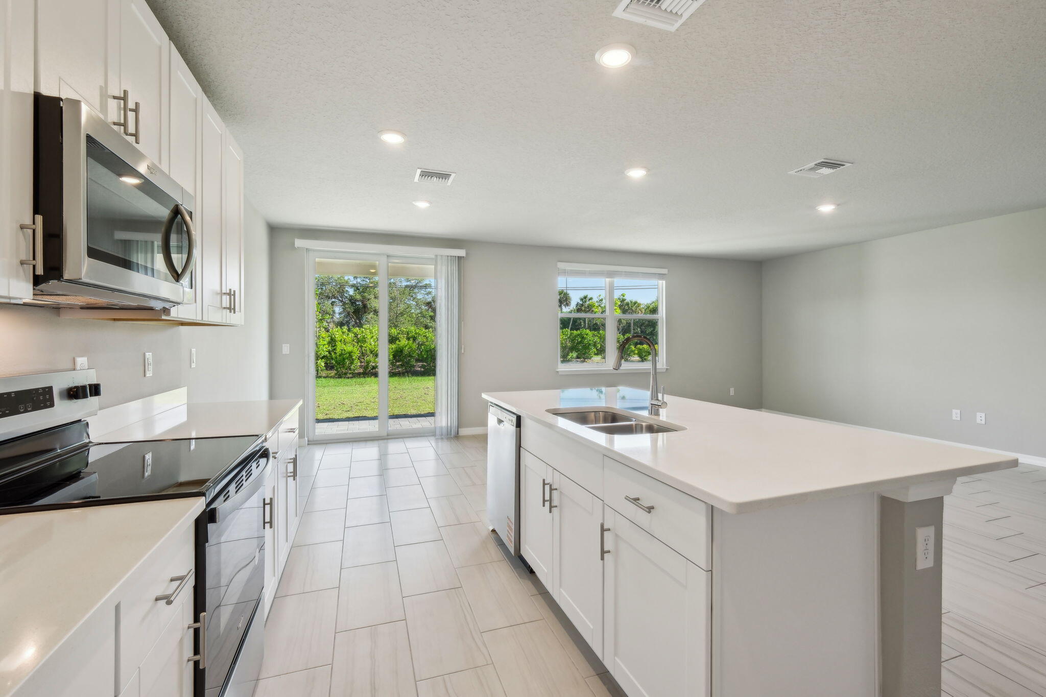 5413 Hampton Park Circle Vero Beach, FL 32966 - Photo 14 of 39 a kitchen with a sink stove and microwave