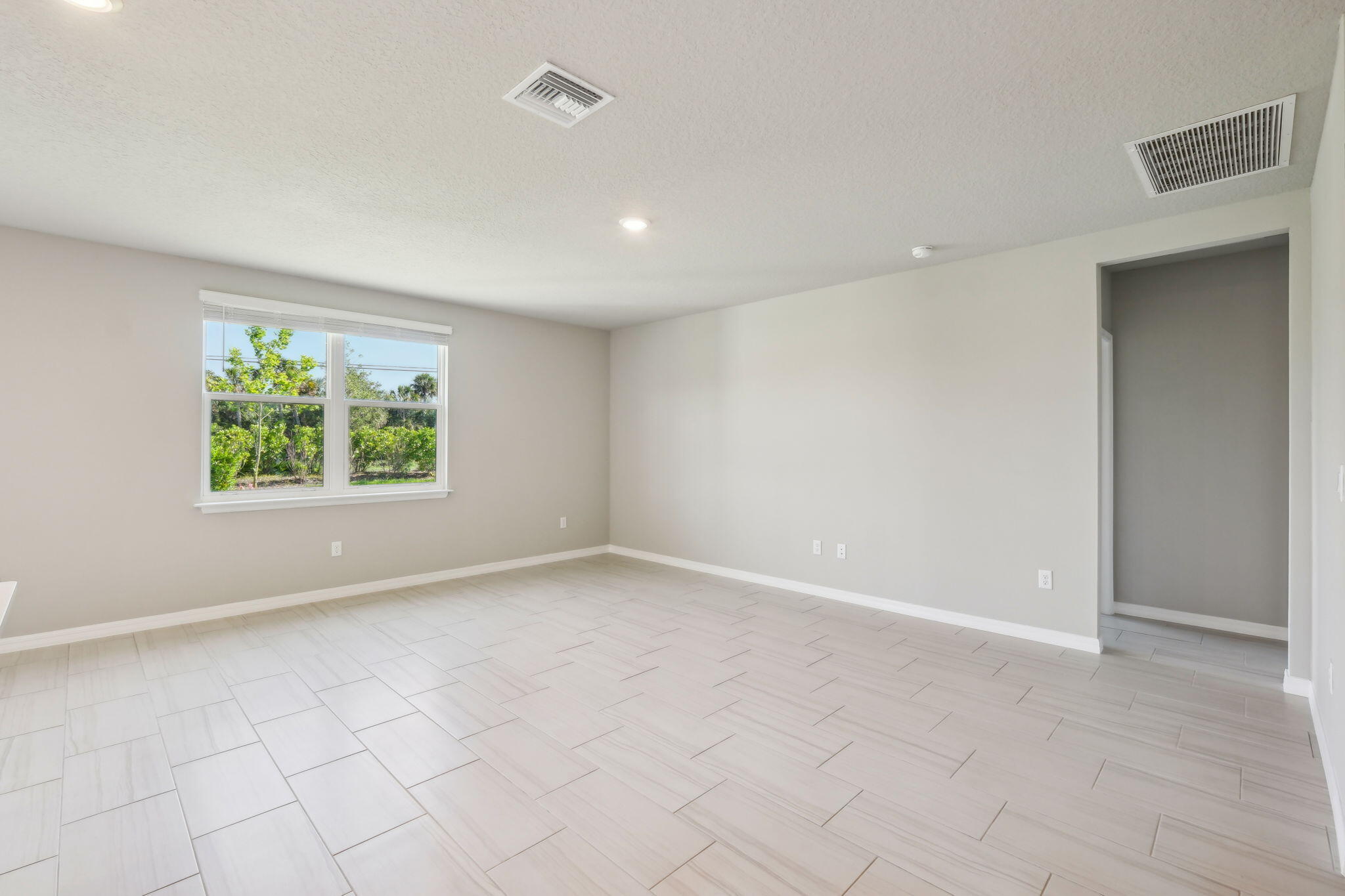 5413 Hampton Park Circle Vero Beach, FL 32966 - Photo 6 of 39 an empty room with windows