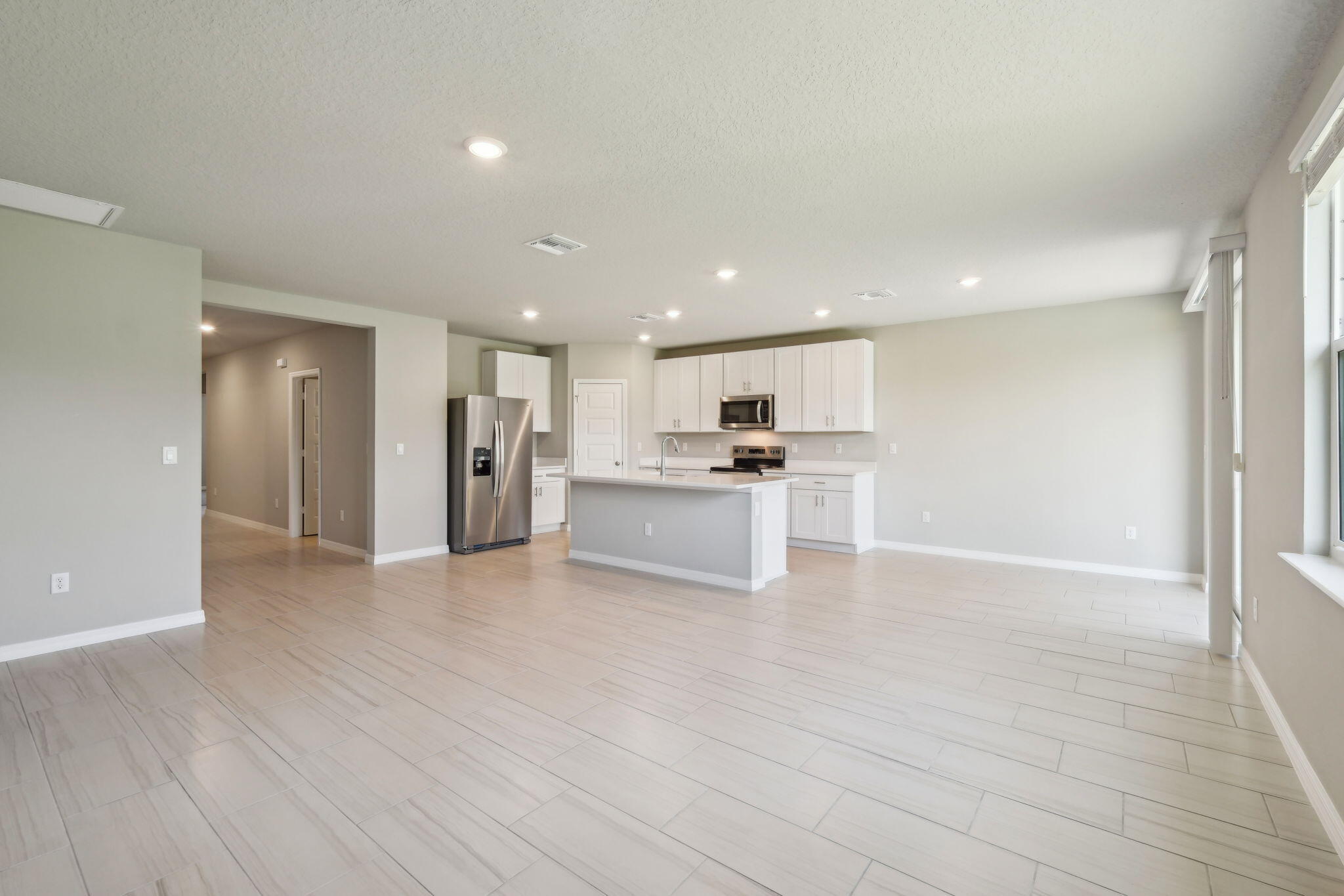 5413 Hampton Park Circle Vero Beach, FL 32966 - Photo 8 of 39 a view of kitchen with stainless steel appliances kitchen island refrigerator stove and a window