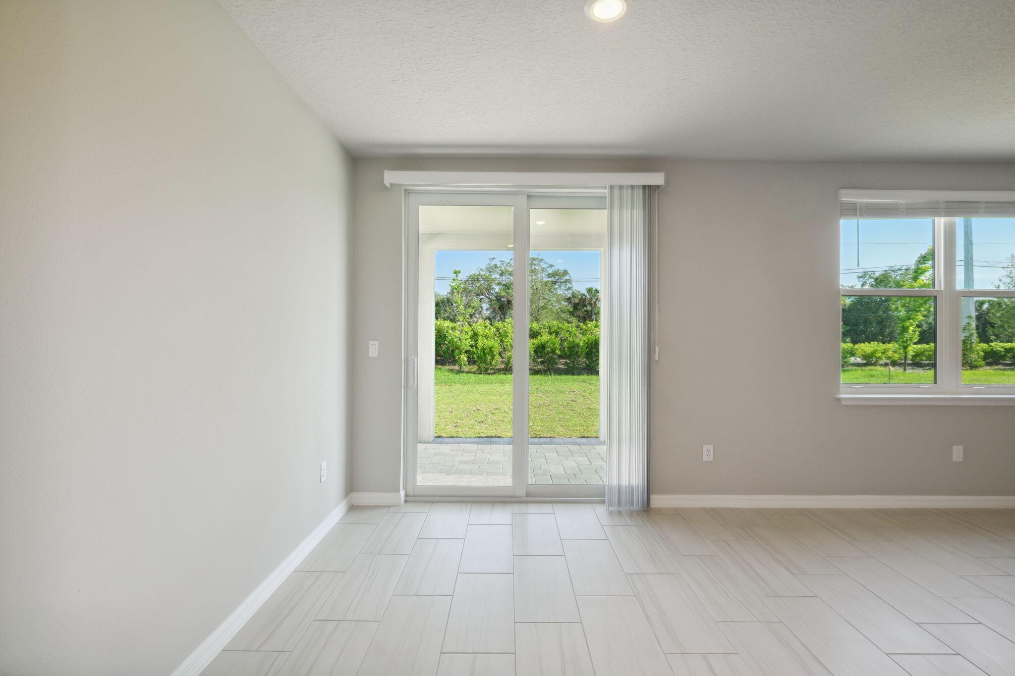 5413 Hampton Park Circle Vero Beach, FL 32966 - Photo 9 of 39 a view of an empty room with wooden floor and a window