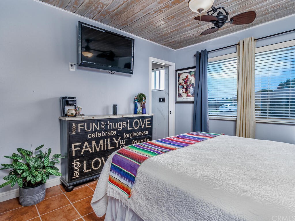 1286 Via Pavion Santa Maria, CA 93455 - Photo 18 of 38 a bedroom with a bed a flat screen tv and a window