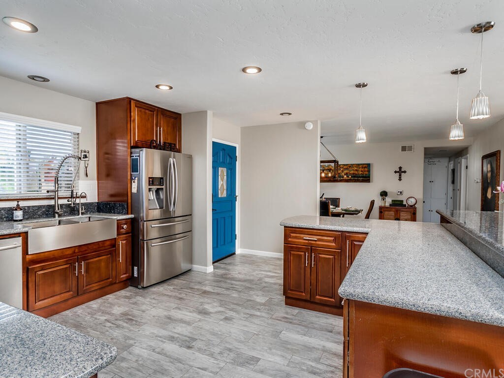 1286 Via Pavion Santa Maria, CA 93455 - Photo 9 of 38 a large kitchen with stainless steel appliances granite countertop a stove refrigerator and a sink with large countertops