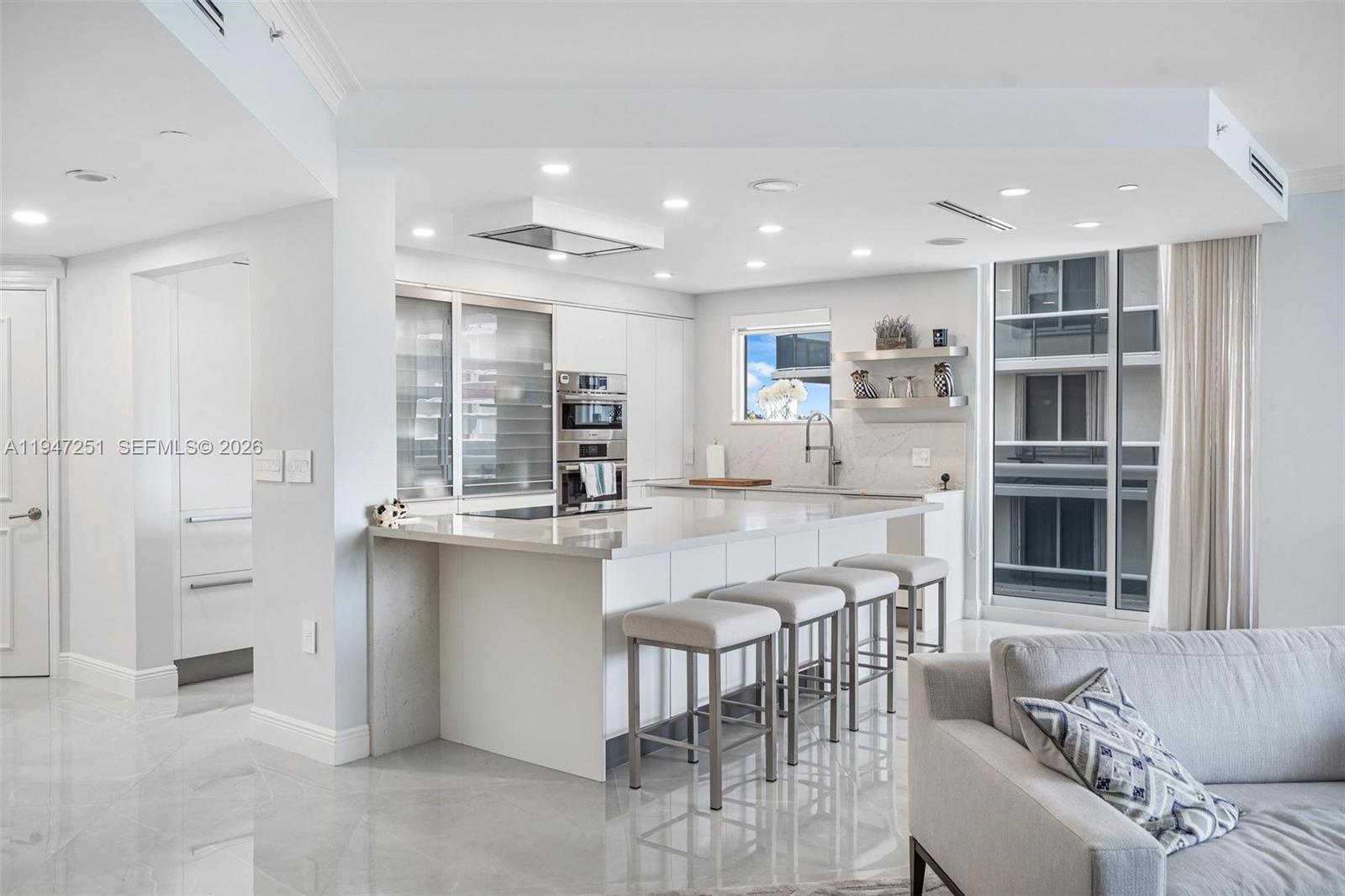 9559 Collins Avenue, Unit S4E Surfside, FL 33154 - Photo 12 of 37 a kitchen with stainless steel appliances granite countertop a stove and a refrigerator