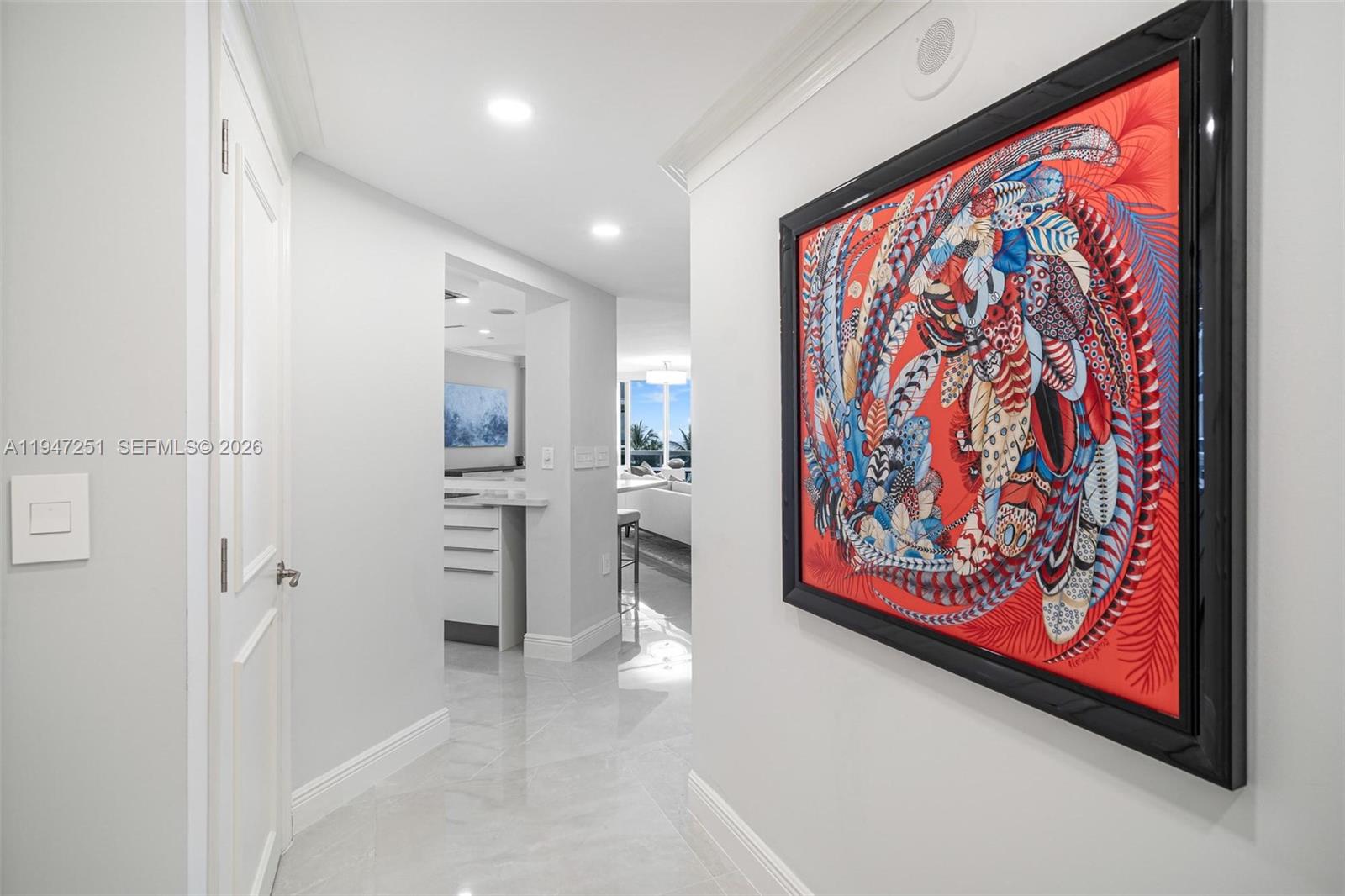 9559 Collins Avenue, Unit S4E Surfside, FL 33154 - Photo 14 of 37 a view of a hallway with wooden floor and a painting on the wall