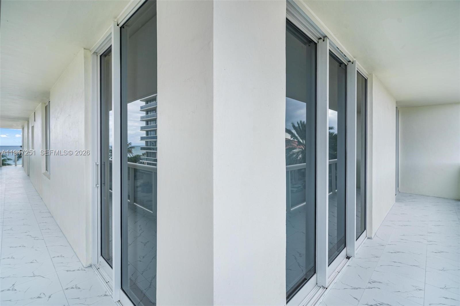9559 Collins Avenue, Unit S4E Surfside, FL 33154 - Photo 34 of 37 a view of a hallway with wooden floor