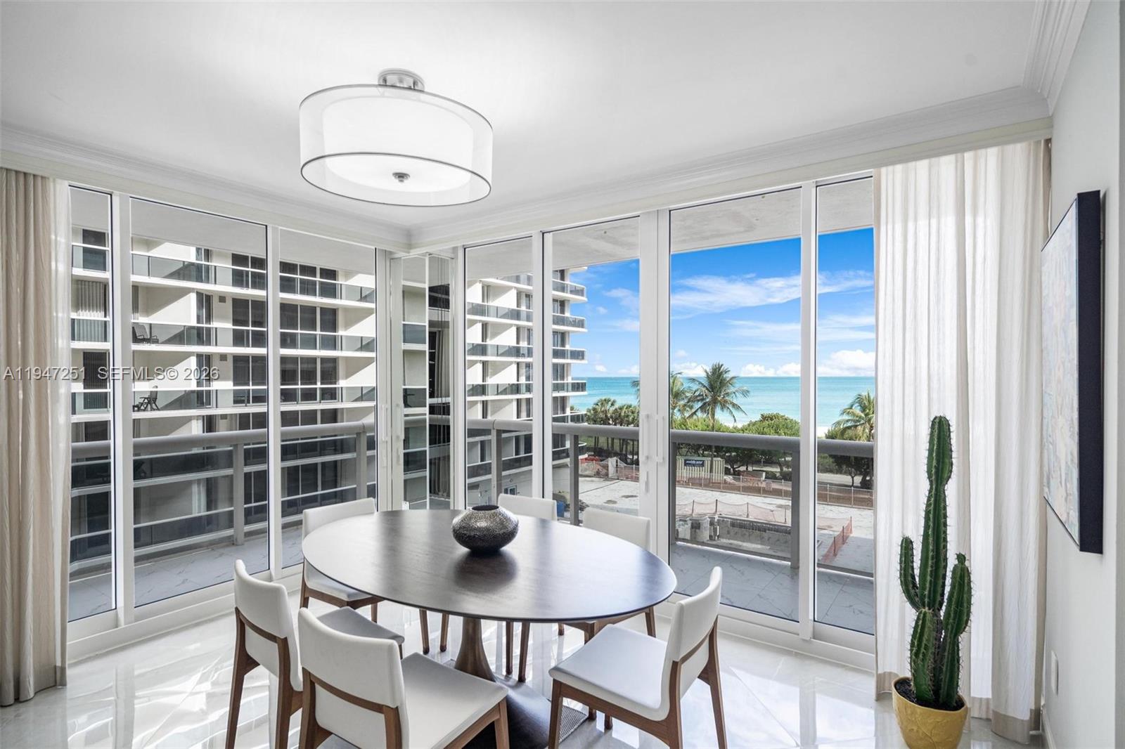 9559 Collins Avenue, Unit S4E Surfside, FL 33154 - Photo 7 of 37 a view of a dining room with furniture and a potted plant