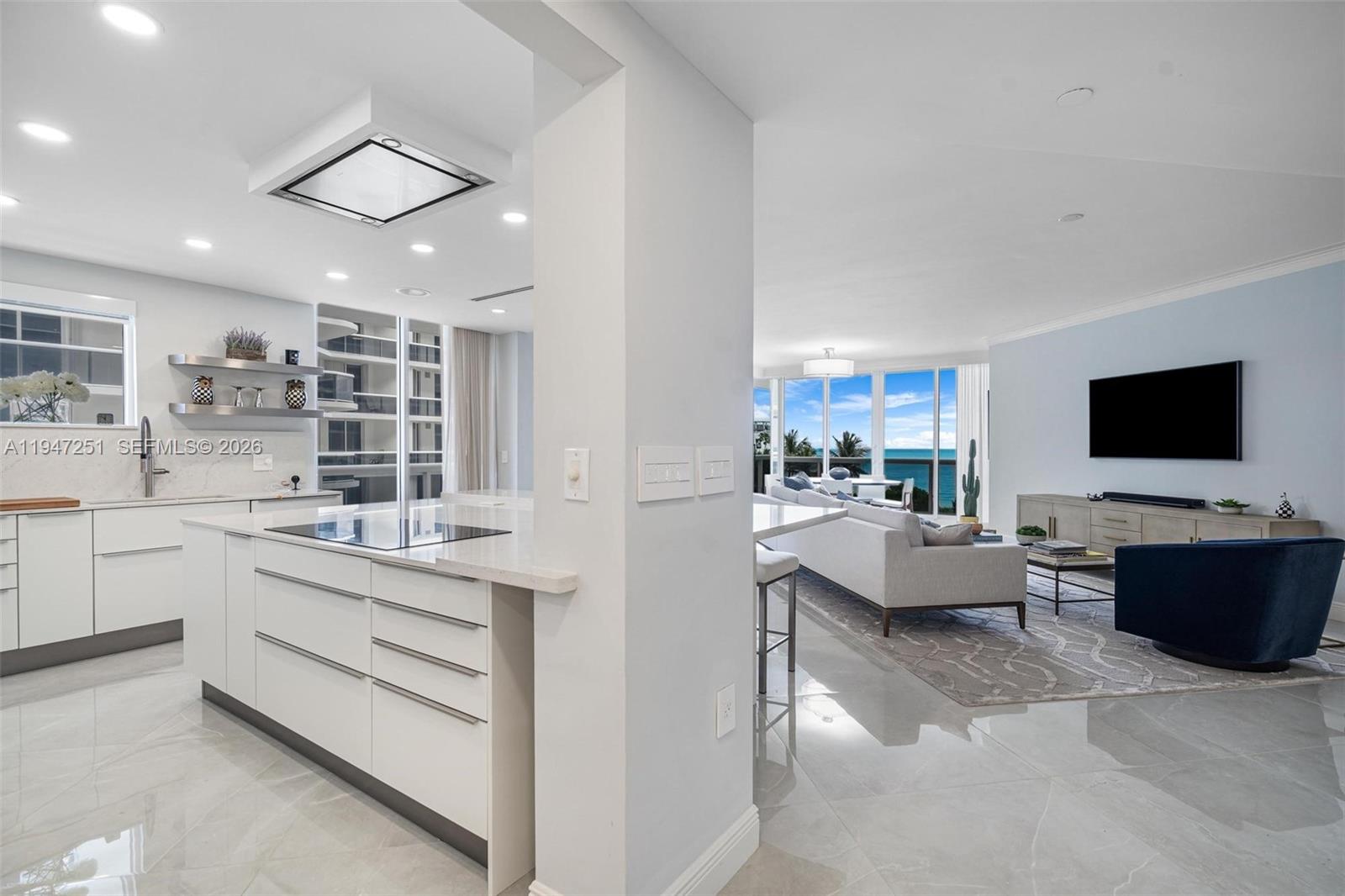 9559 Collins Avenue, Unit S4E Surfside, FL 33154 - Photo 8 of 37 a living room with furniture and a flat screen tv