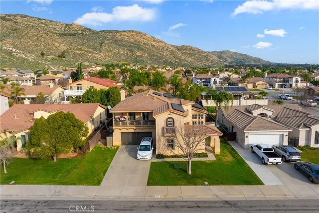 a aerial view of a house with a garden and mountains