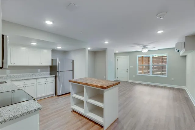 a kitchen with stainless steel appliances granite countertop a stove and a refrigerator
