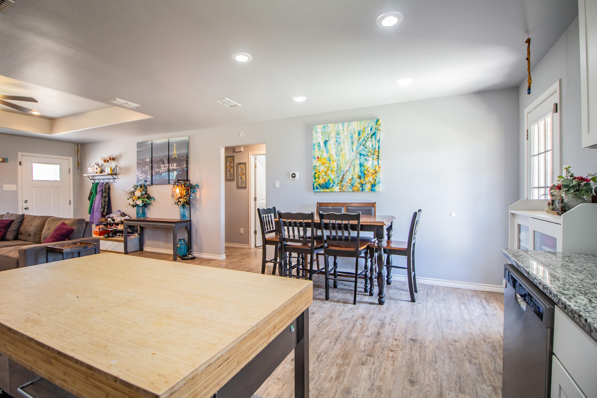 8805 15th Street Lubbock, TX 79416 - Photo 11 of 20 a view of a dining room with furniture and wooden floor