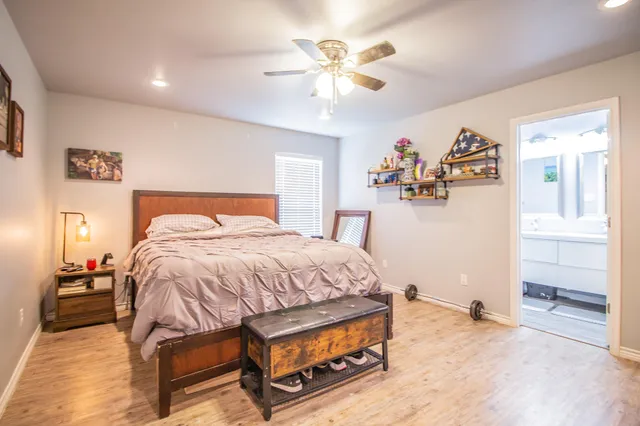 a bedroom with a bed and a chandelier