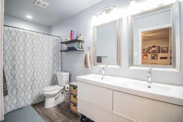 a bathroom with a sink toilet and a mirror