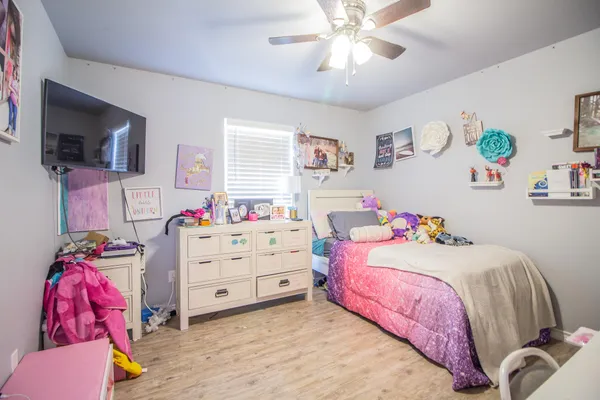 a bedroom with a bed and a flat screen tv