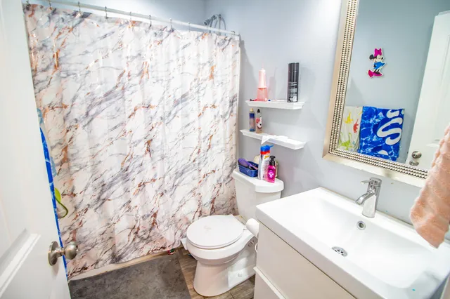 a white toilet sitting next to a bathroom sink