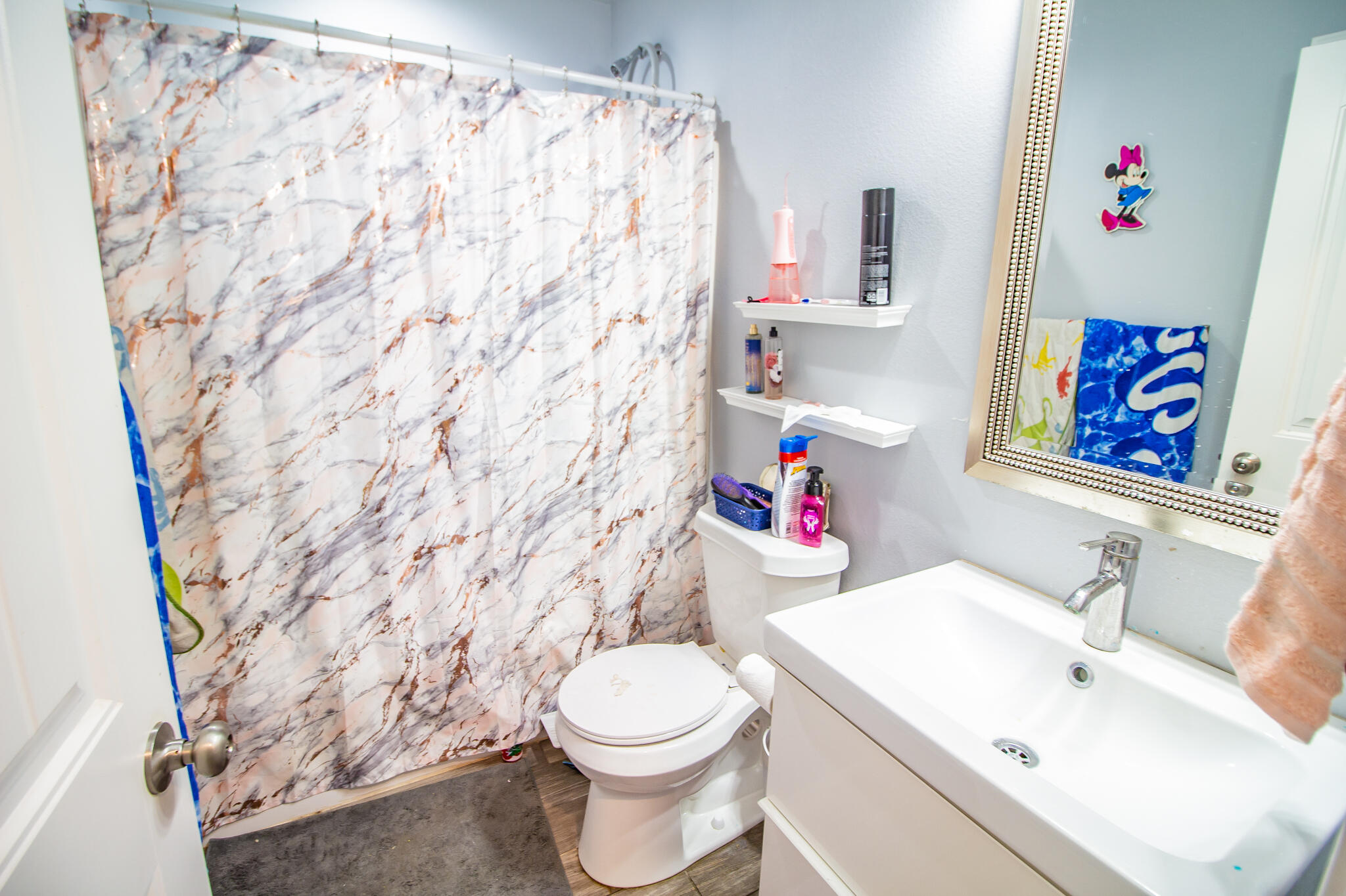 8805 15th Street Lubbock, TX 79416 - Photo 16 of 20 a white toilet sitting next to a bathroom sink