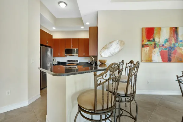 a kitchen with stainless steel appliances granite countertop a sink counter space cabinets and a large window