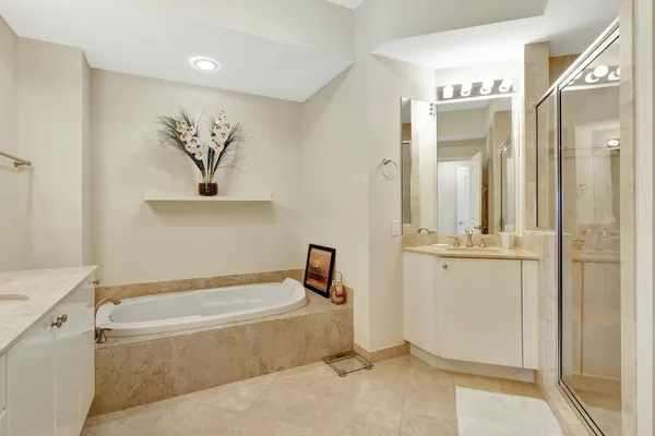 a bathroom with a granite countertop sink a toilet and mirror