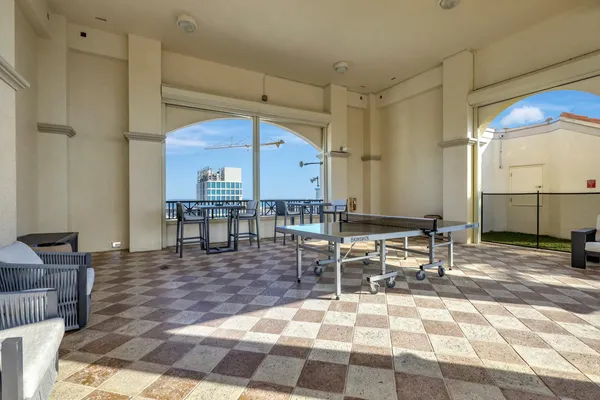a outdoor space with lots of tables a chair and mirrors