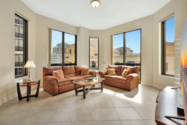 a living room with furniture and a floor to ceiling window