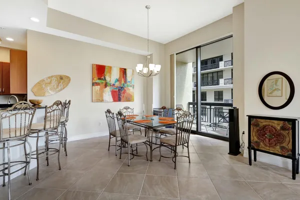 a view of a dining room with furniture and a chandelier