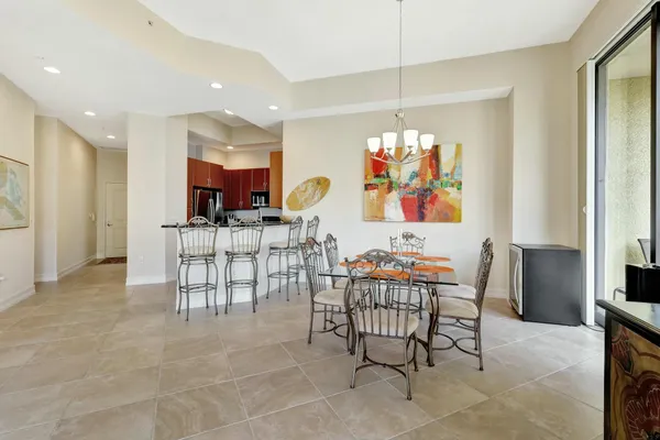 a view of a dining room with furniture a chandelier and window