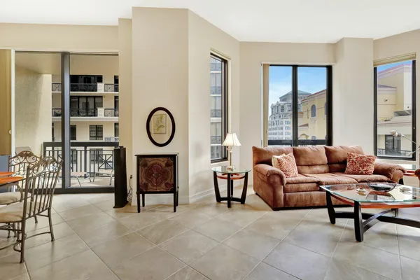 a living room with furniture a rug and a window