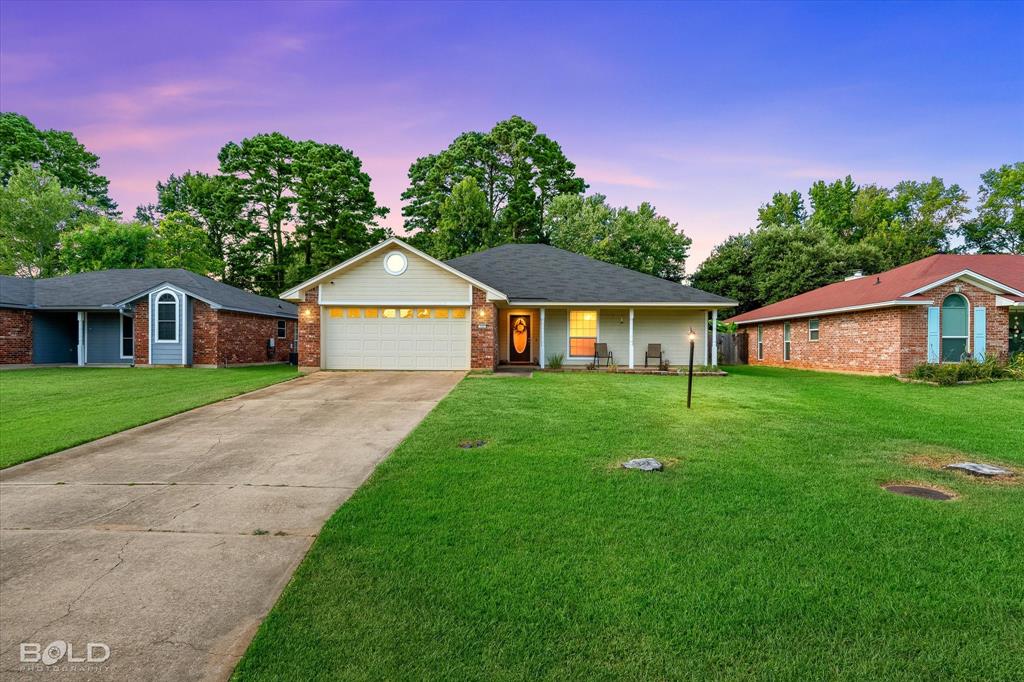 122 Ragan Lane Haughton, LA 71037 - Photo 23 of 34 Brick and siding exterior with a covered porch, attached two-car garage, and concrete driveway