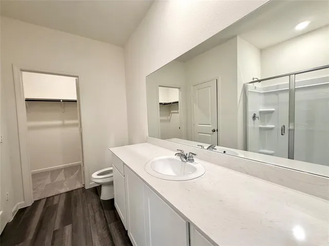 a bathroom with a sink toilet and shower