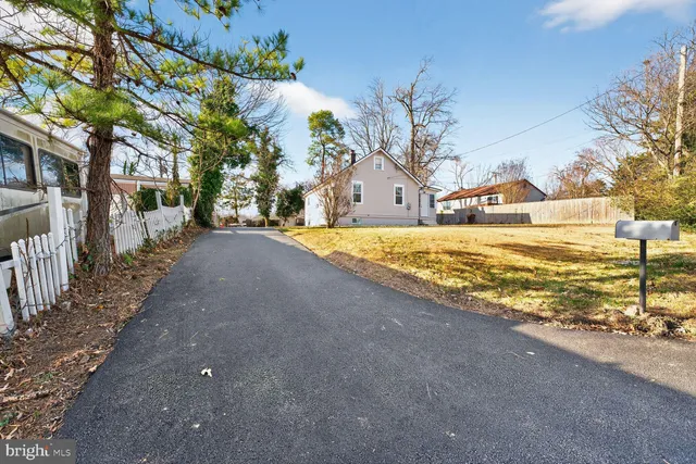 a view of a house with a yard and tree