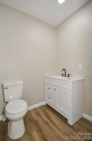 a bathroom with a toilet sink and vanity