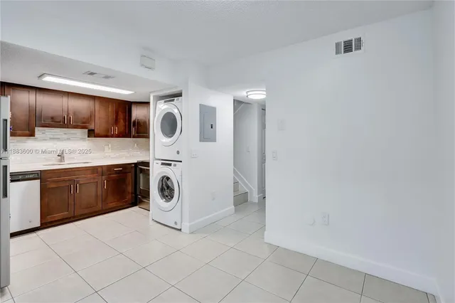 a utility room with sink dryer and washer